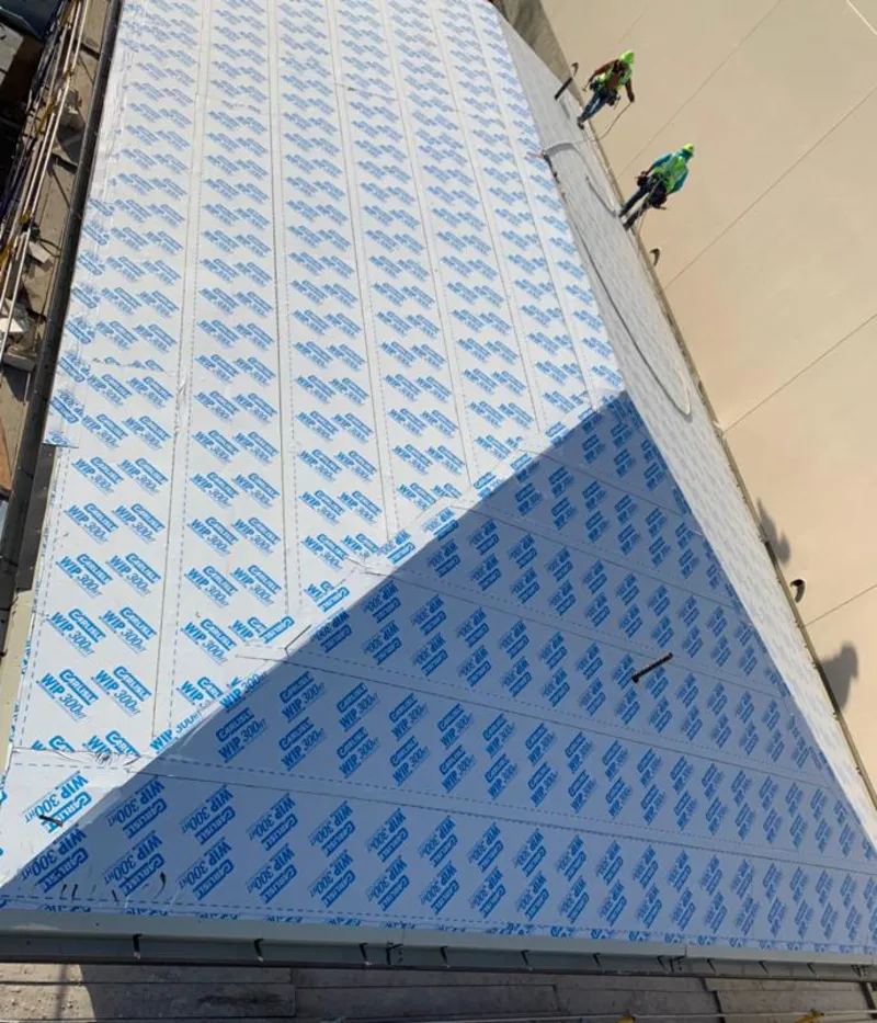 Professional roofers installing underlayment on a metal roof in Grandview Heights